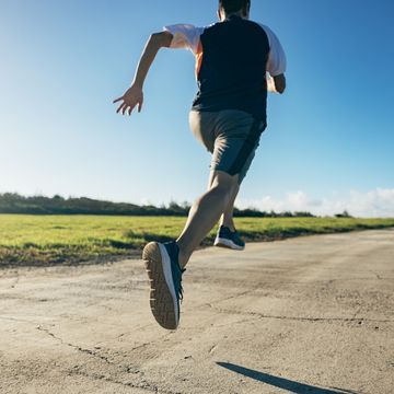 the asian man is running with all his might, putting in his strength and fully concentrating on the exercise.