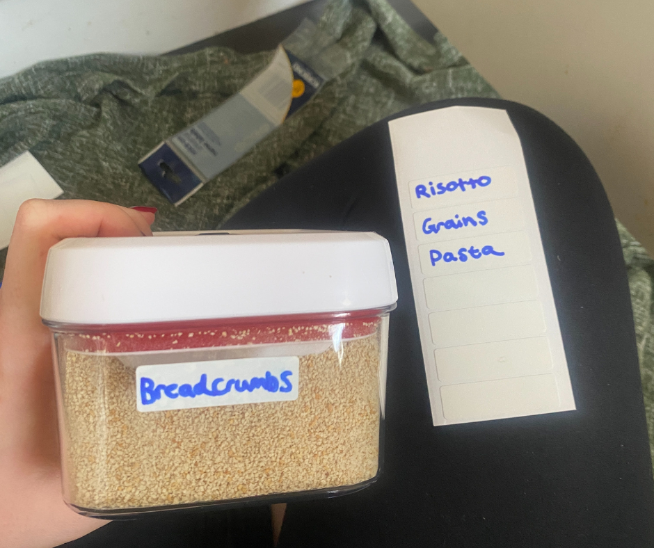 container of breadcrumbs and a labeled card for pantry organization