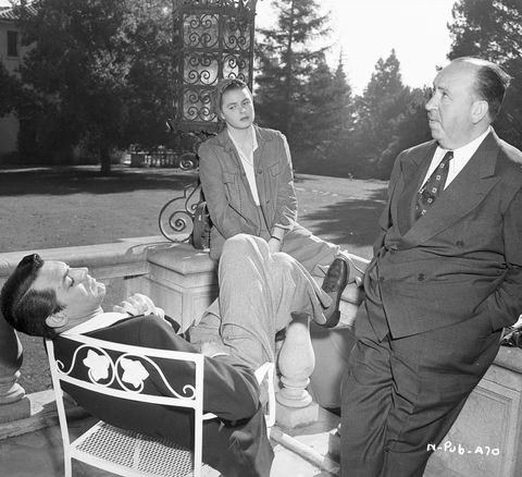 ingrid bergman, cary grant, and alfred hitchcock taking a break