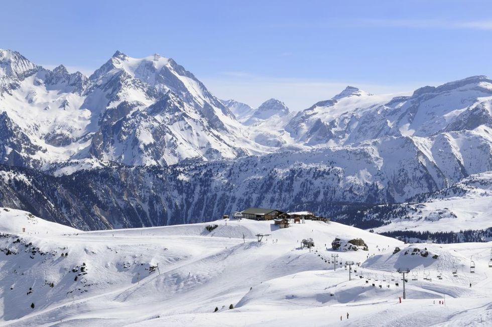 view on the slopes and vanoise mountains, courchevel ski resort, tree valley skiing area, savoie, france