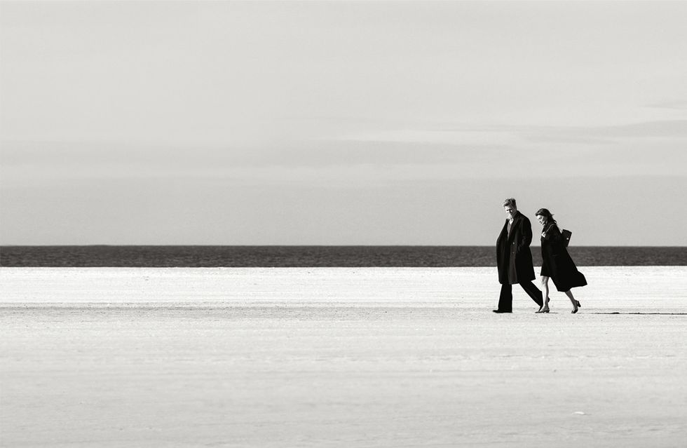 a man and woman walking on ice