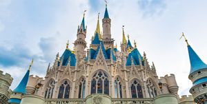 the cinderella castle during an overcast day is seen in the