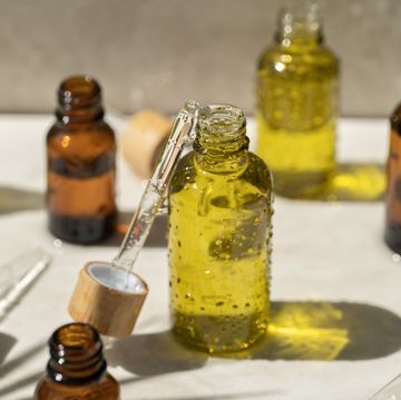dropper bottles with oil on white table