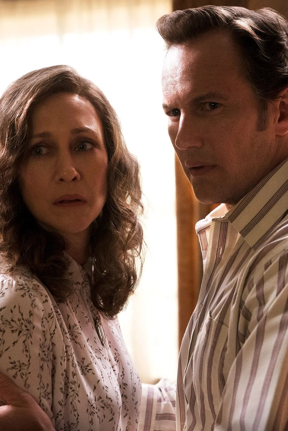 ed and lorraine warren look afraid in a scene from 'the conjuring'