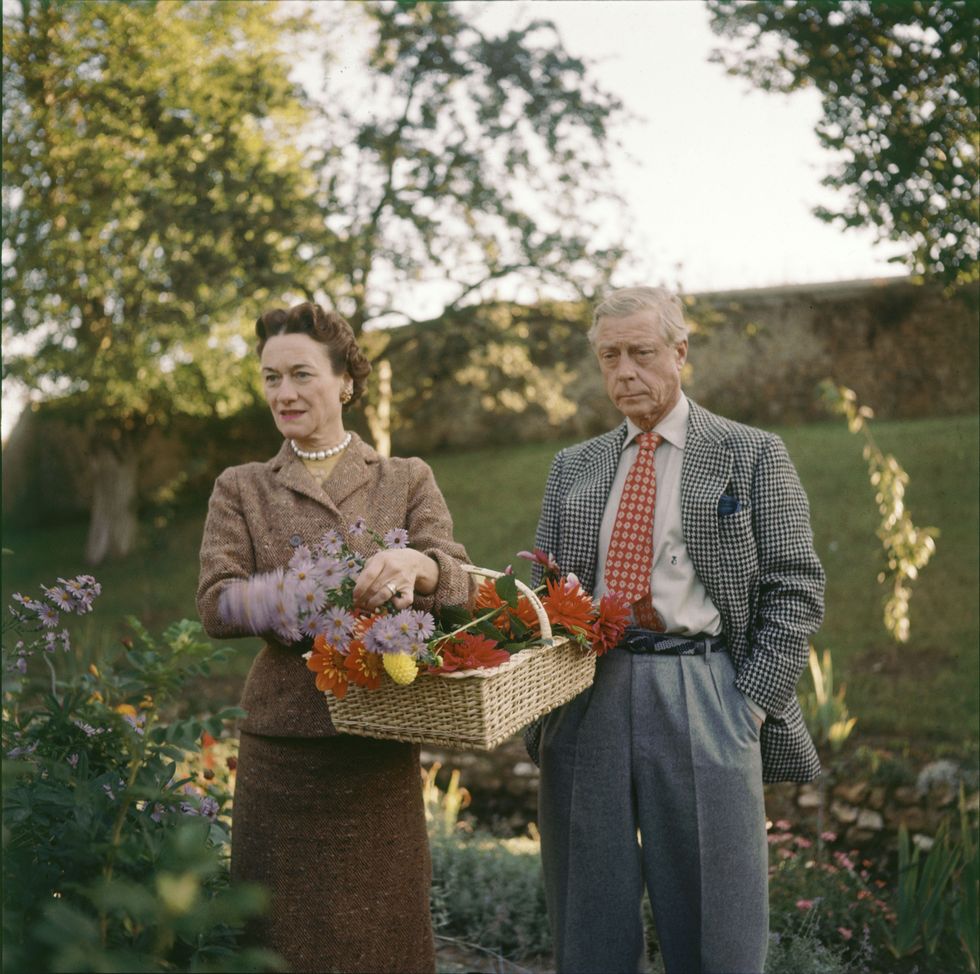 The Duchess and Duke of Windsor pick flowers on the grounds of their home, la Moulin de la Tuilerie, in the commune of Gif-sur-Yvette, outside of Paris, France, 1955.
