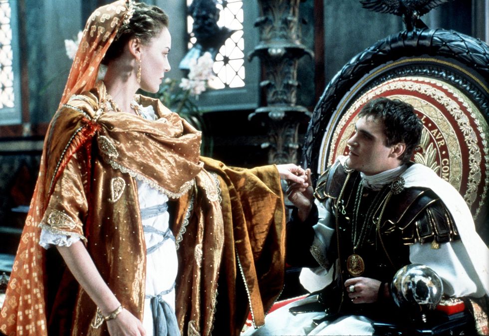 a publicity photo from the film gladiator, with joaquin phoenix and connie nielsen in a throne room wearing ancient rome attire