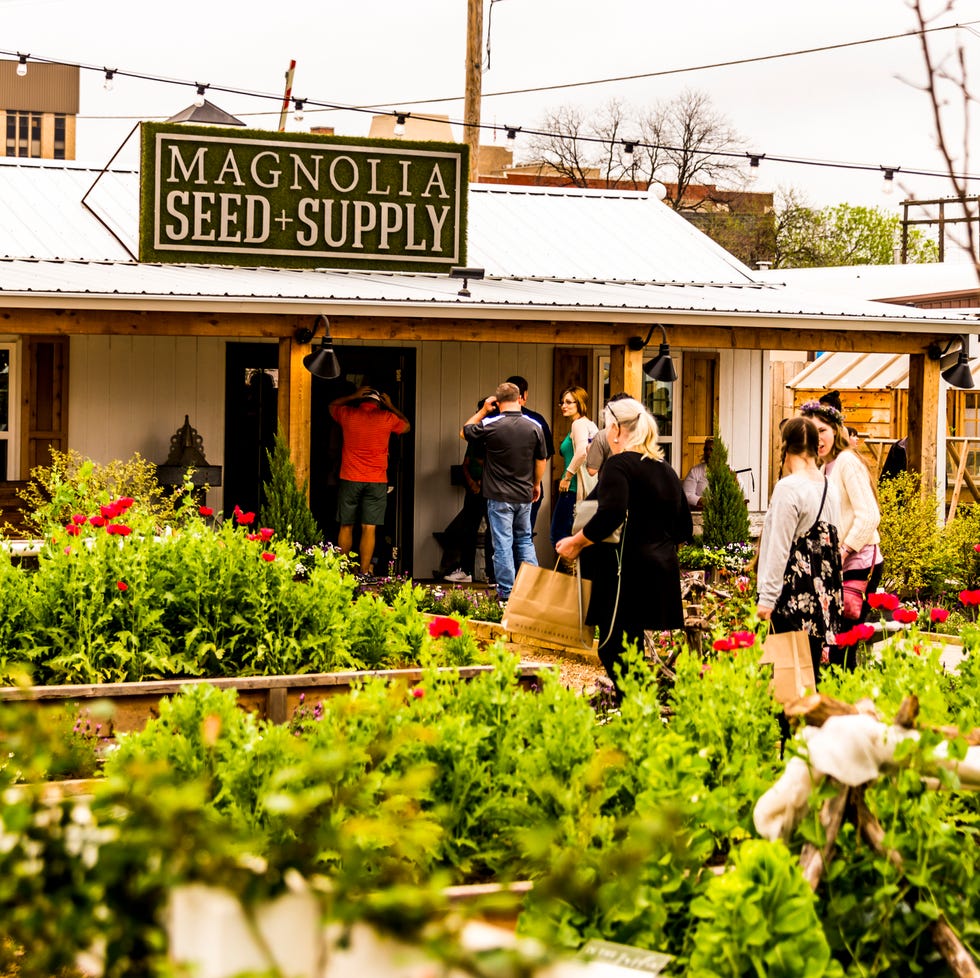 WACO, TX, USA MARCH 18, 2017: The entrance to Magnolia Seed and Supply overlooking plants in the garden area of Magnolia Silos. waco, tx, usa march 18, 2017 the entrance to magnolia seed and supply overlooking plants in the garden area of magnolia silos