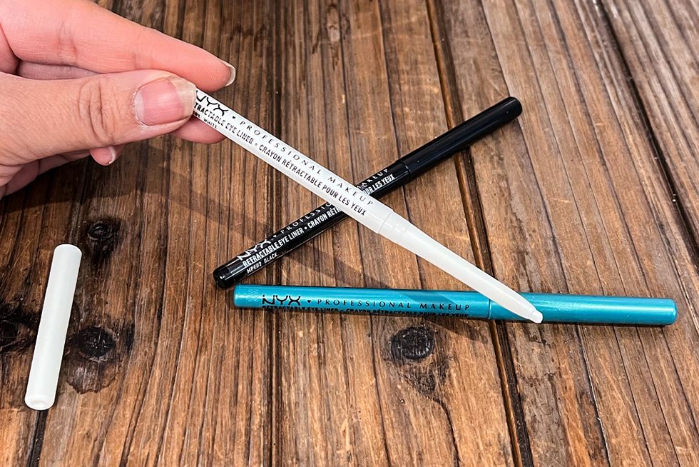 the eyeliner pencils on the table showing the tip of the pencil and the colors
