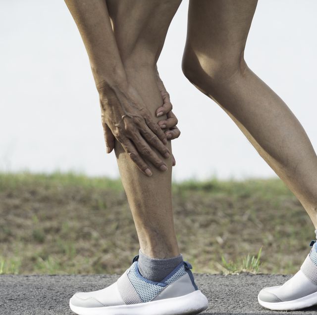 the female clings to a bad leg. the pain in her leg. health and painful concept.