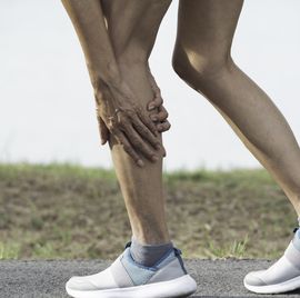 the female clings to a bad leg. the pain in her leg. health and painful concept.