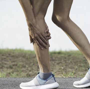 the female clings to a bad leg. the pain in her leg. health and painful concept.