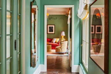 a hallway with green doors