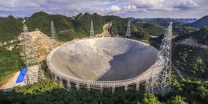 the 500 meter aperture spherical telescope is nestled within a natural basin in china