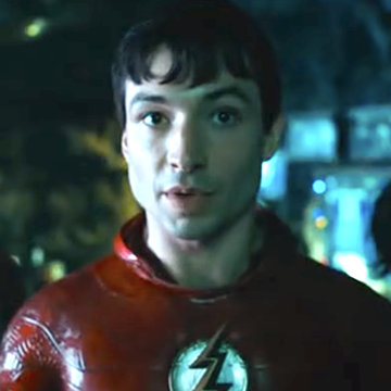 ezra miller wearing red superhero costume with lightning bolt logo in the flash