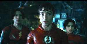 ezra miller wearing red superhero costume with lightning bolt logo in the flash