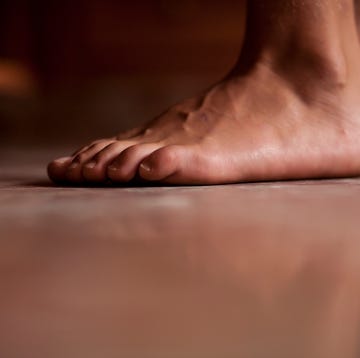 The foreground of bare feet. To the Ground The foreground of bare feet. To the Ground