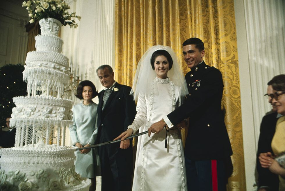 lyndon johnson and wife watching daughter cut wedding cake
