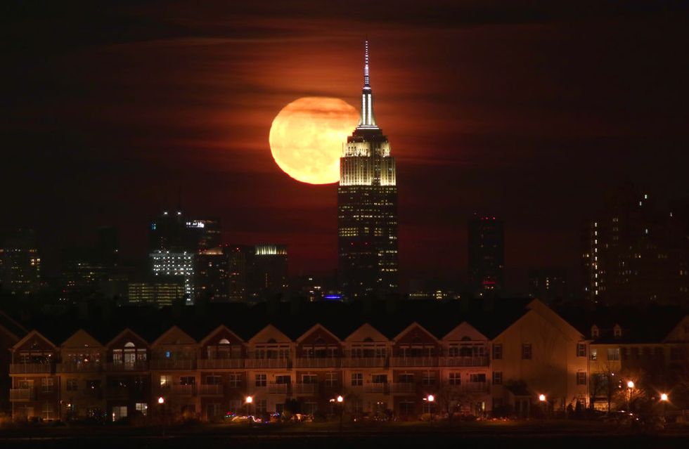 Full Moon Rises Behind the Empire State Building in New York City