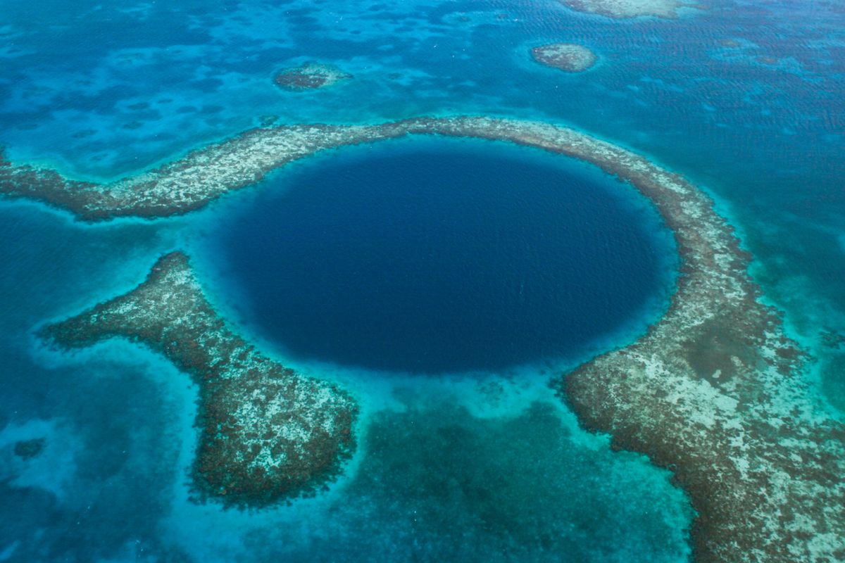 the-great-blue-hole-off-the-coast-of-belize-in-royalty-free-image-1682795059.jpg?resize=1200:*