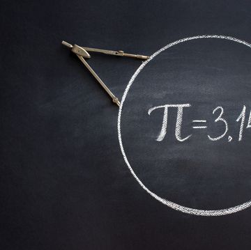 the greek letter pi, the ratio of the circumference of a circle to its diameter, is drawn in chalk on a black chalkboard with a compass in honor
