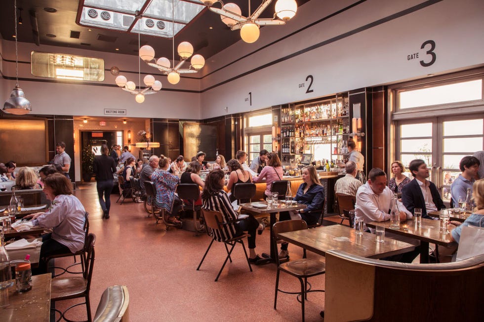 a group of people sitting at tables at the grey