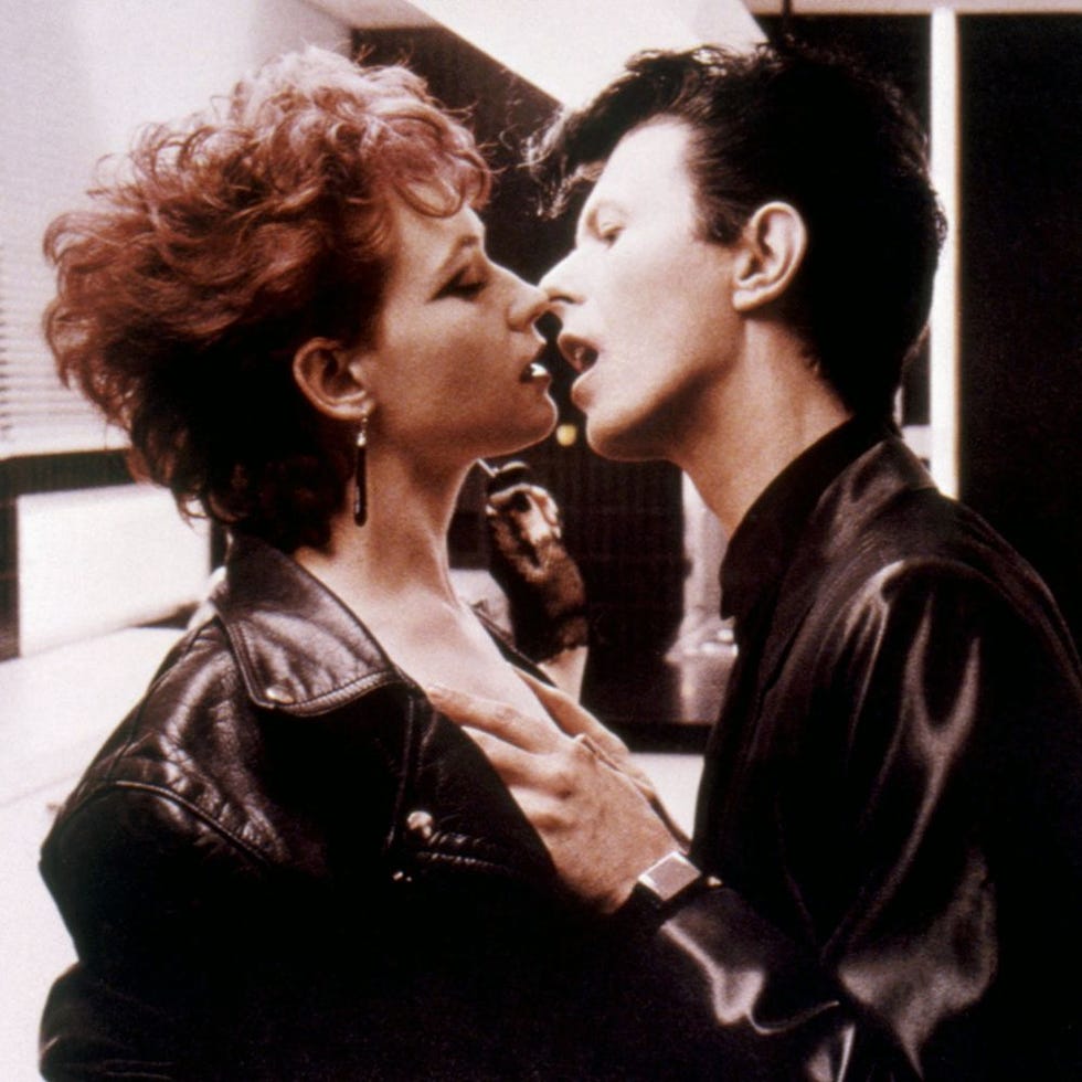 a close interaction between two individuals in a stylish setting