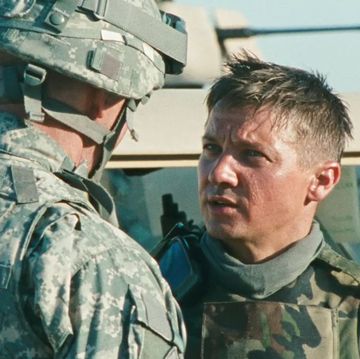 a man in military uniform looking at another man in a military uniform