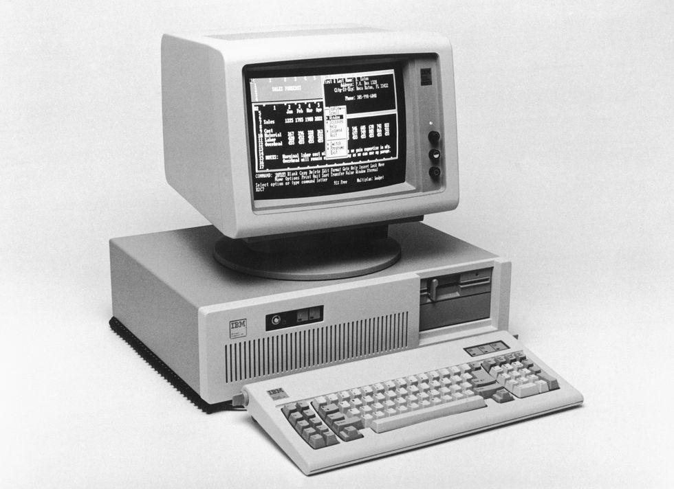 an early computer with a monitor and keyboard, the monitor displays numbers in a grid