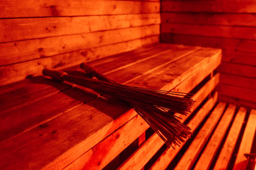 the infrared sauna is lined with wooden slats inside wooden wreaths lie on the bench