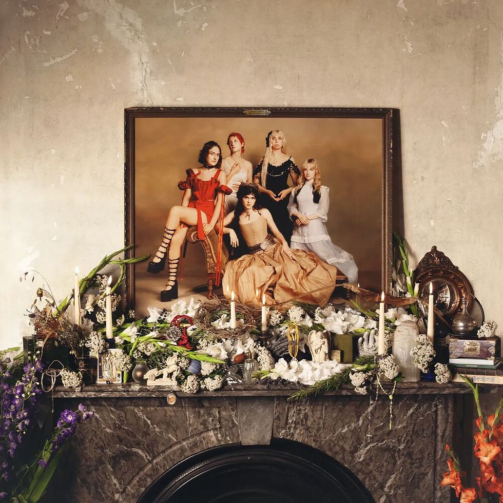 the last dinner party album cover featuring the girls on a painting above a fireplace