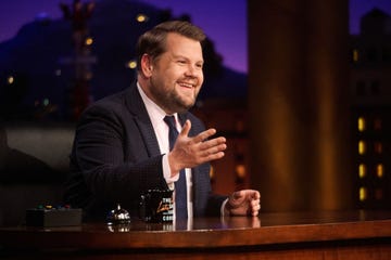 james corden smiling while talking to the audience off camera