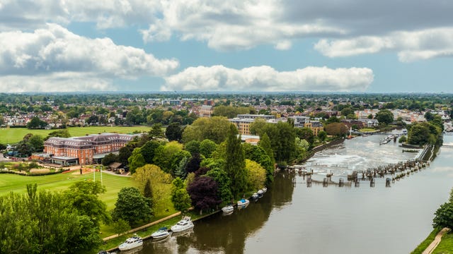 aerial view of a hotel and sports grounds beside a river