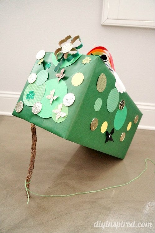 a green decorated box with craft materials representing a whimsical tree