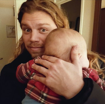 jonathan meijer holding a baby and looking forward into a camera in a screenshot from 'the man with 1000 kids'