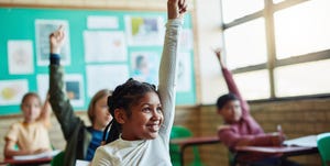 happy, confident kid raising her hand in class in a story about self advocacy
