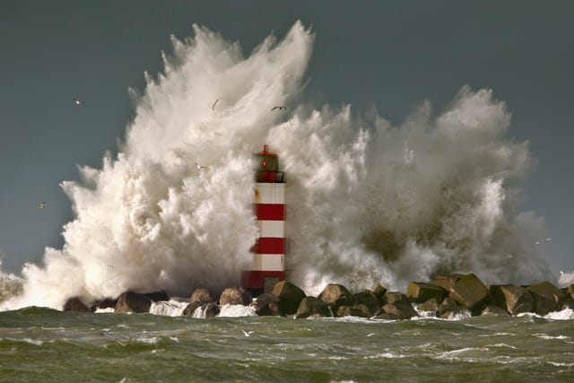 the netherlands, ijmuiden, storm waves smash against beacon