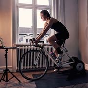 women cyclist riding indoors on a bike trainer