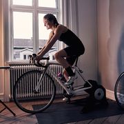 women cyclist riding indoors on a bike trainer