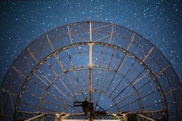 the plate of a radio telescope antenna under starry sky