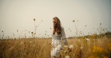 kate walks through field