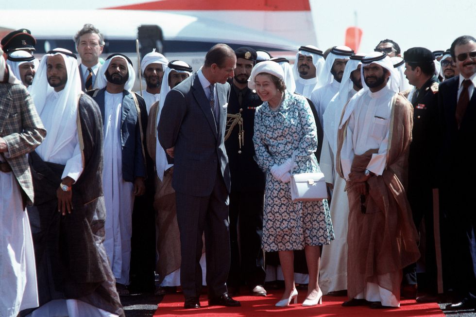 queen and philip laughing in the gulf