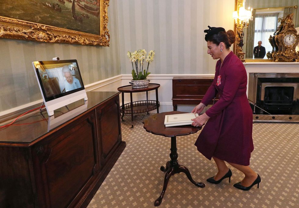 queen elizabeth ii l appears on a screen by videolink from windsor castle, during a virtual audience to receive her excellency sophie katsarava r, the ambassador of georgia, who was at londons buckingham palace on december 4, 2020   today, britains queen elizabeth ii conducted the first virtual audiences from buckingham palace, via video link from windsor castle photo by yui mok  pool  afp photo by yui mokpoolafp via getty images