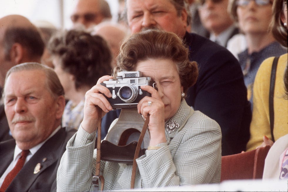 queen elizabeth holding a camera