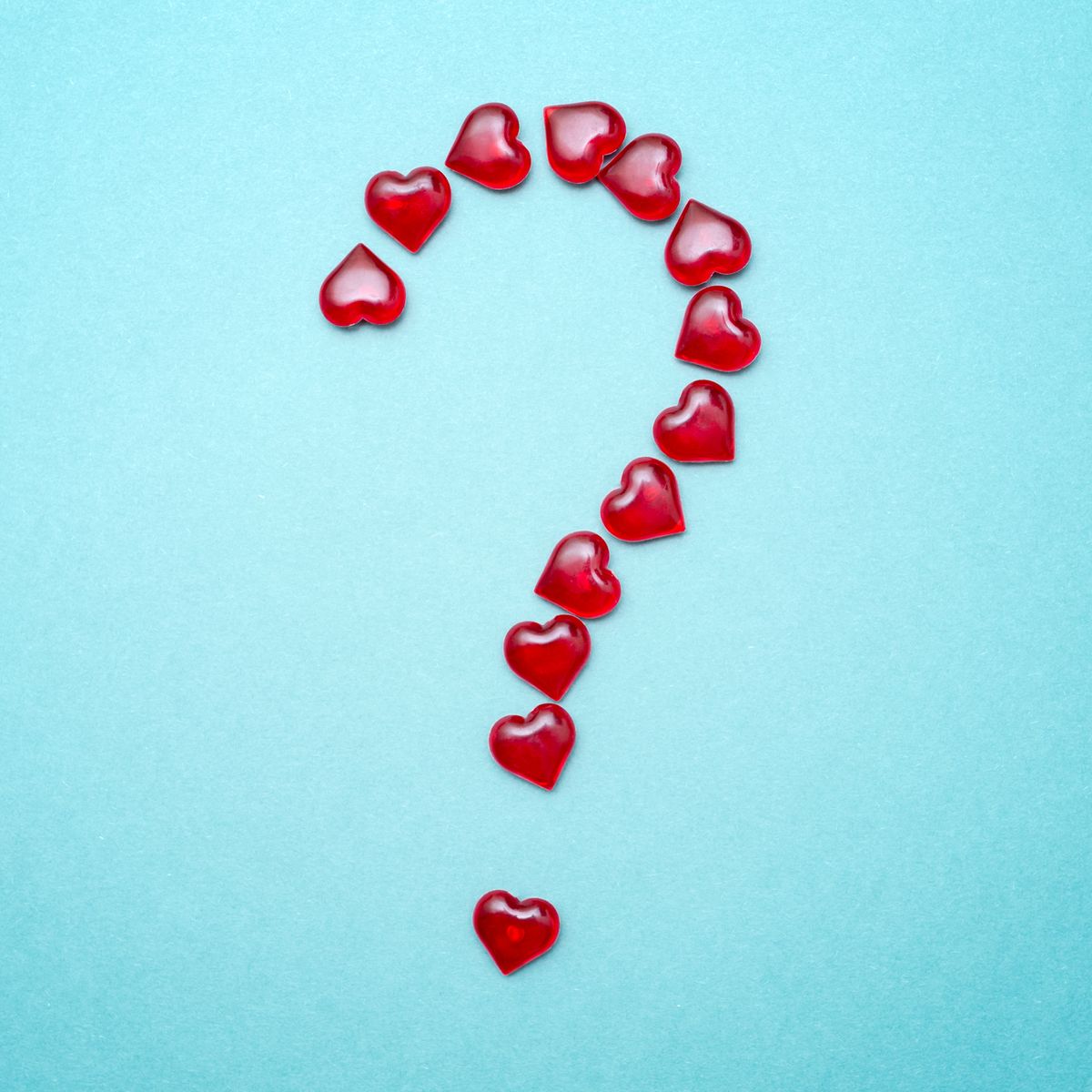 the question mark in the form of red hearts on a blue background
