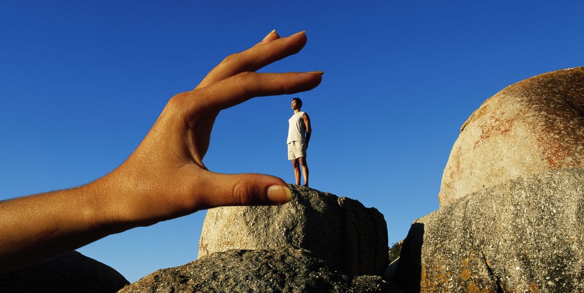 6'1" Because Apparently That Matters a hand positioned to give the illusion of holding a person standing on a rock formation