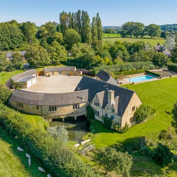 round cotswold stone house with pool for sale in gloucestershire
