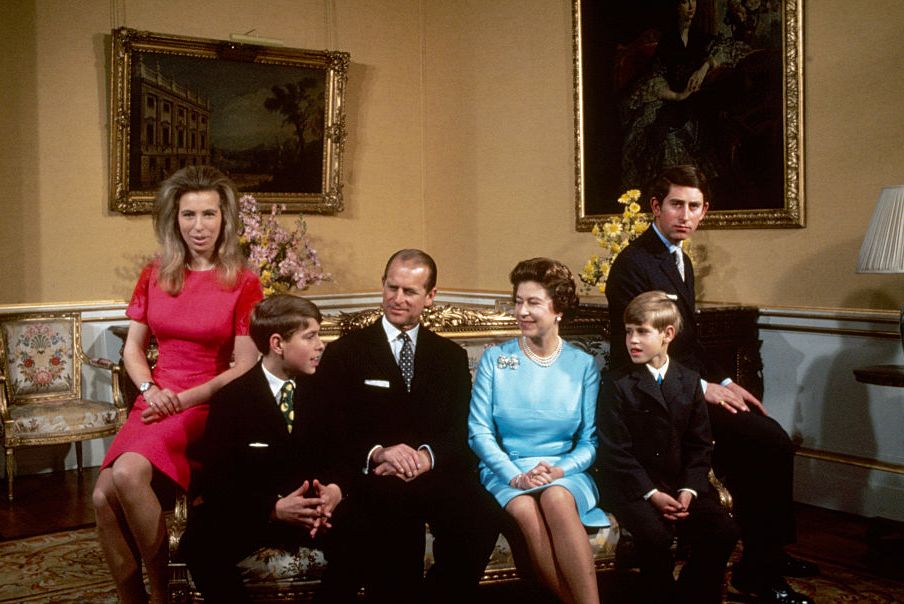 princess anne, prince andrew, prince philip, queen elizabeth ii, prince edward, and prince charles sit on a couch in a living room