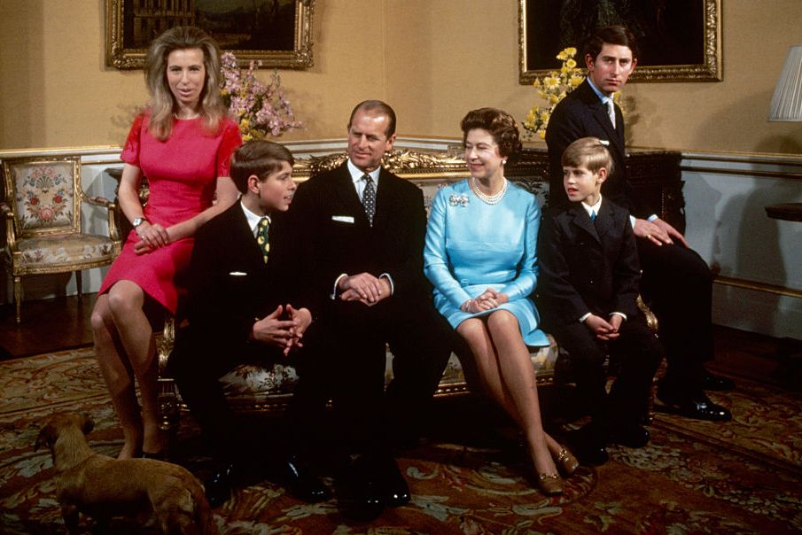 princess anne, prince andrew, prince philip, queen elizabeth ii, prince edward, and prince charles sit on a couch in a living room