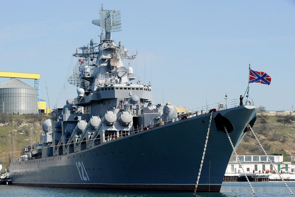 moskva docked in a bay with a flag at its front