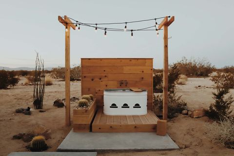 outdoor tub on deck with string lights